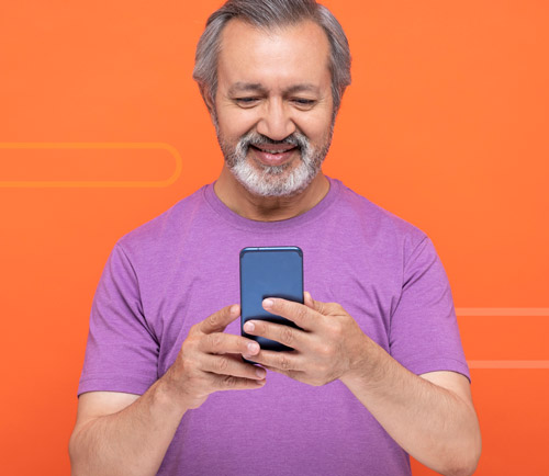 Photo of a person using a smartphone, against a bright orange background