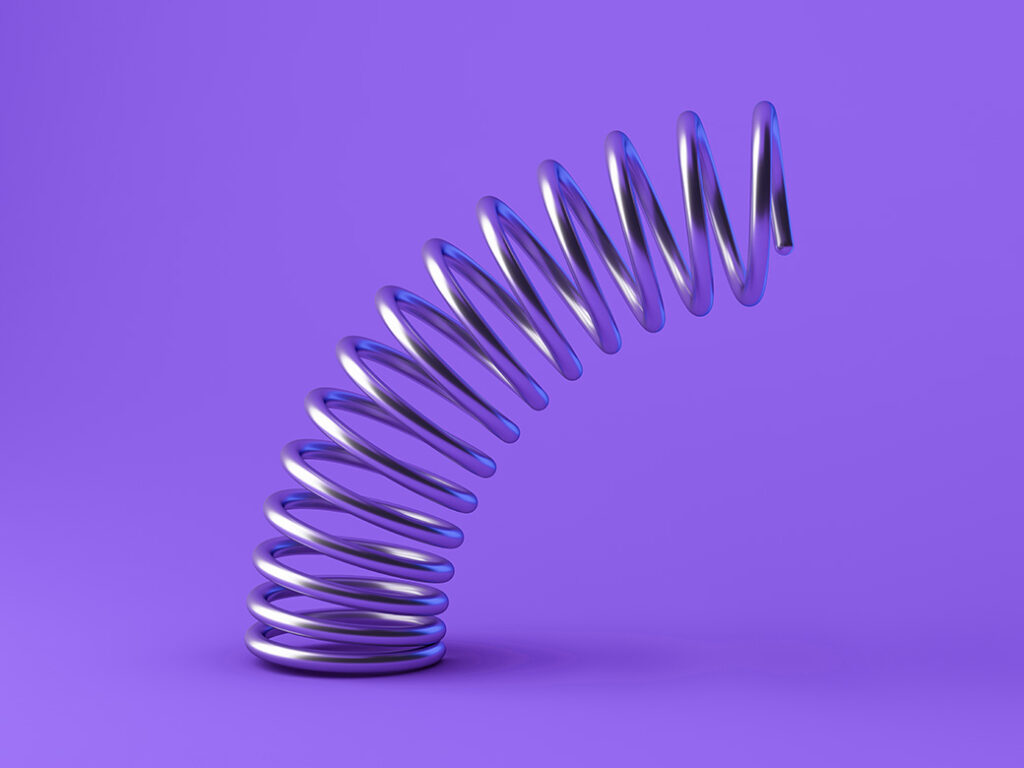 Photo of a slinky bent over on a purple background
